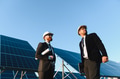 Engineers inspecting solar panel farm for renewable energy production - PhotoDune Item for Sale