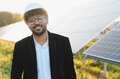 Arab businessman wearing hardhat smiling in solar panel farm - PhotoDune Item for Sale