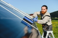 Technician cleaning solar panels for efficient green energy production - PhotoDune Item for Sale