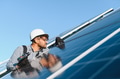 Technician installing solar panels on building roof - PhotoDune Item for Sale