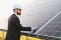 Investor inspecting solar panel farm for sustainable energy production - PhotoDune Item for Sale