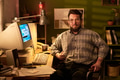 Portrait of Caucasian Man Sitting at Desk Holding Baseball - PhotoDune Item for Sale