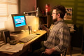 Caucasian Man Using Desktop Computer While Drinking Coffee - PhotoDune Item for Sale