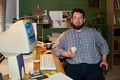 Portrait of Adult Caucasian Man Holding Baseball While Sitting at Desk - PhotoDune Item for Sale