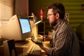 Caucasian Man Using Calculator While Working on Desktop Computer - PhotoDune Item for Sale