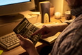 Middle Aged Man Using Calculator While Working at Desk in Office - PhotoDune Item for Sale
