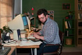 Caucasian Man Working with Vintage Computer and Calculator Indoors - PhotoDune Item for Sale