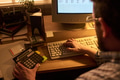 Caucasian Man Using Calculator and Computer While Working Late - PhotoDune Item for Sale