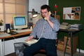 Caucasian Man Talking on Landline Telephone in Retro Office Setting - PhotoDune Item for Sale