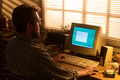 Caucasian Man Typing on Vintage Computer during Sunset Hours - PhotoDune Item for Sale