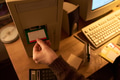 Caucasian Young Adult Woman Inserting Floppy Disk into Vintage Computer - PhotoDune Item for Sale
