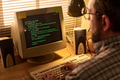 Middle Aged Caucasian Man Typing Code on Vintage Computer in Home Office - PhotoDune Item for Sale