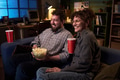 Caucasian Couple Laughing Together While Watching Movie at Home - PhotoDune Item for Sale