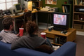 Young Caucasian Man and Woman Watching Movie Together in Retro Living Room - PhotoDune Item for Sale