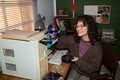 Caucasian Woman Inserting Disc into Computer While Smiling - PhotoDune Item for Sale