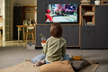 Girl Watching Animated Show on Television While Drinking Juice - PhotoDune Item for Sale