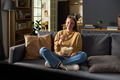 Portrait of Young Adult Woman Sitting on Sofa Eating Popcorn - PhotoDune Item for Sale