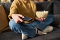 Woman Holding Remote and Popcorn While Selecting Channel - PhotoDune Item for Sale