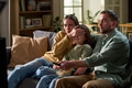 Parents Watching Movie with Child While Mother Covering Eyes - PhotoDune Item for Sale