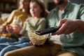 Family Watching Television Together While Sitting on Sofa at Home - PhotoDune Item for Sale