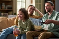 Family Relaxing Together Watching Television and Eating Popcorn - PhotoDune Item for Sale
