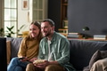 Young Adult Couple Watching Television and Smiling Together Indoors - PhotoDune Item for Sale