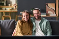 Young Adult Couple Smiling While Sitting Together on Sofa - PhotoDune Item for Sale
