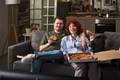 Young Man and Young Woman Eating Pizza on Sofa Smiling - PhotoDune Item for Sale