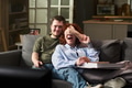 Young Man Covering Eyes of Young Woman While Watching Tv - PhotoDune Item for Sale