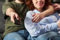 Young Man Hugging Young Woman While Holding Remote Control - PhotoDune Item for Sale