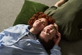 Young Lovers Lying on Floor Resting Heads Together with Eyes Closed - PhotoDune Item for Sale