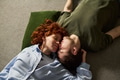 Young Couple Lying on Floor Embracing and Relaxing Together - PhotoDune Item for Sale