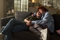 Young Couple Relaxing Together on Sofa and Embracing Affectionately - PhotoDune Item for Sale