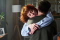 Young Adult Woman Hugging Young Adult Man Indoors Showing Affection - PhotoDune Item for Sale