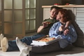 Young Man and Young Woman Eating Pizza and Relaxing Together - PhotoDune Item for Sale