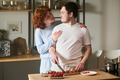 Young Couple Preparing Food Together and Smiling in Kitchen - PhotoDune Item for Sale