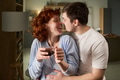 Young Couple Smiling and Embracing While Drinking Hot Beverage - PhotoDune Item for Sale