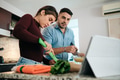 Couple Cooking Together And Watching Tutorial - PhotoDune Item for Sale