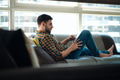 Man Choosing Movie For Streaming On Tablet - PhotoDune Item for Sale
