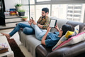 Young Couple Reading Ebook With Ereader On Couch - PhotoDune Item for Sale