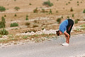 Determined Female Athlete Stretching After an Intense Run Through Rugged Mountain Terrain. - PhotoDune Item for Sale