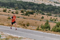 Determined Athlete Running Through Rugged Mountain Terrain at Sunrise. - PhotoDune Item for Sale