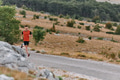 Determined Athlete Running Through Rugged Mountain Terrain at Sunrise. - PhotoDune Item for Sale