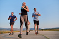 A group of friends maintains a healthy lifestyle by running outdoors on a sunny day, bonding over - PhotoDune Item for Sale