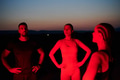 Diverse Athletes Unwind: Post-Marathon Rest Under Red Nighttime Glow. - PhotoDune Item for Sale