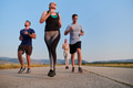 A group of friends maintains a healthy lifestyle by running outdoors on a sunny day, bonding over - PhotoDune Item for Sale