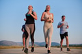 A group of friends maintains a healthy lifestyle by running outdoors on a sunny day, bonding over - PhotoDune Item for Sale