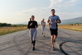 A group of friends maintains a healthy lifestyle by running outdoors on a sunny day, bonding over - PhotoDune Item for Sale