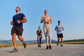 A group of friends maintains a healthy lifestyle by running outdoors on a sunny day, bonding over - PhotoDune Item for Sale
