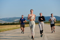 A group of friends maintains a healthy lifestyle by running outdoors on a sunny day, bonding over - PhotoDune Item for Sale